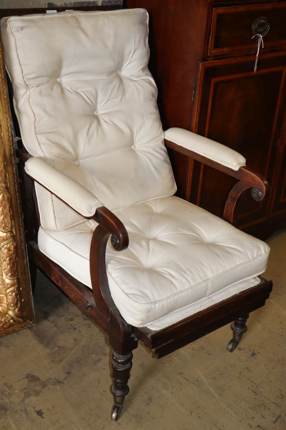 An early Victorian rosewood reclining armchair